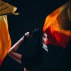 Elegant young gymnast striking a pose with vibrant flowing fabric.