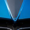 Detailed view of a blue carbon fiber car, showcasing its sleek aerodynamic design.
