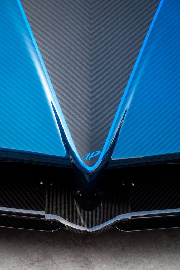 Detailed view of a blue carbon fiber car, showcasing its sleek aerodynamic design.