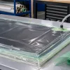 Carbon fiber laminate under a vacuum bag with flow media and resin trap