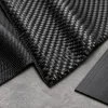 Fine and coarse carbon fiber weaves with a unidirectional material sample