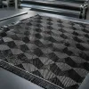Custom geometric carbon fiber fabric sample on an OEM inspection table
