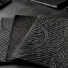 Jacquard carbon fiber fabric swatches with varied woven patterns